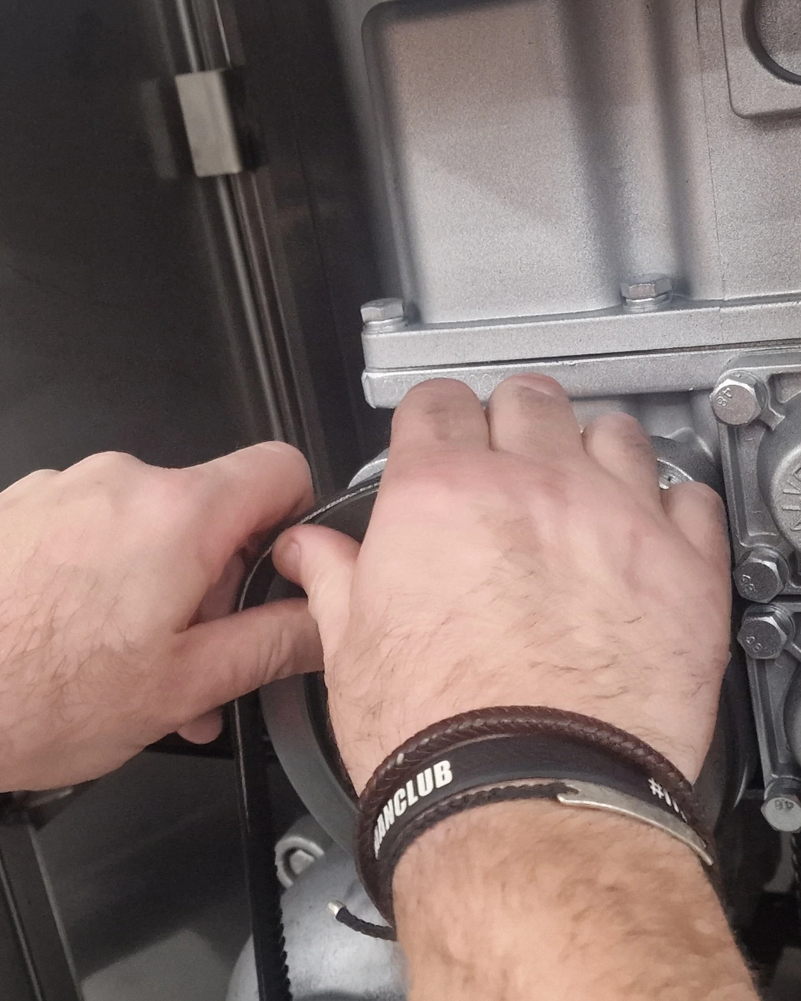 Hands inspecting internal fuel management components