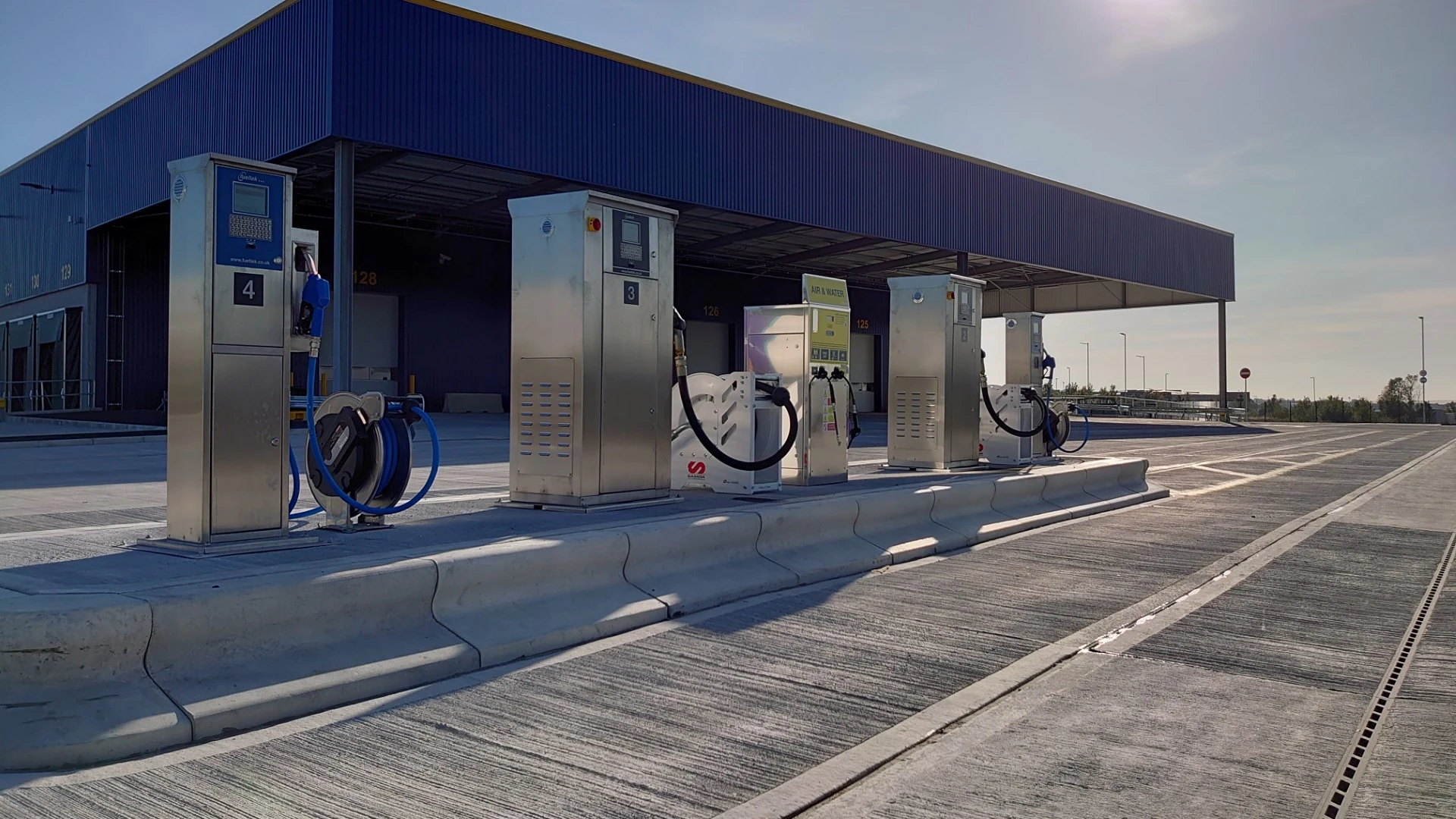 A line of Fueltek dispensing units at a covered commercial fuelling island.